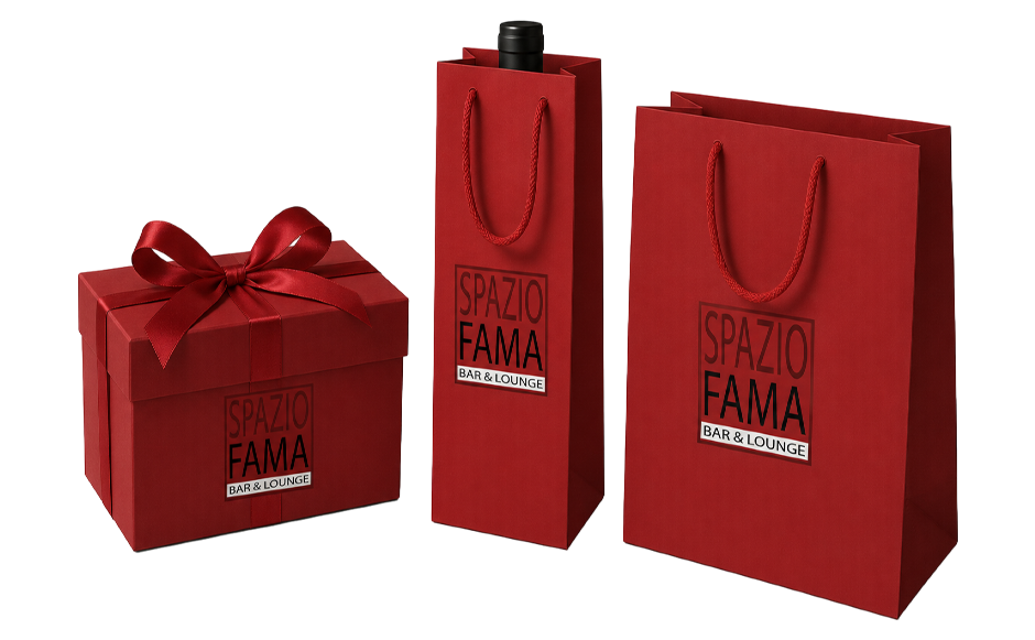 Spazio Fama retail packaging: a ribbon-tied gift box, a single-bottle carrier, and a shopping bag in house red